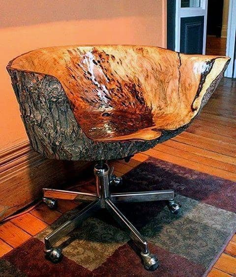 Rustic carved wood office chair with bark exterior and metal swivel base.