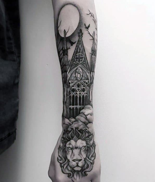 Forearm tattoo of a gothic cathedral window with a full moon, flying birds, and a realistic lion head at the wrist for a regal look.