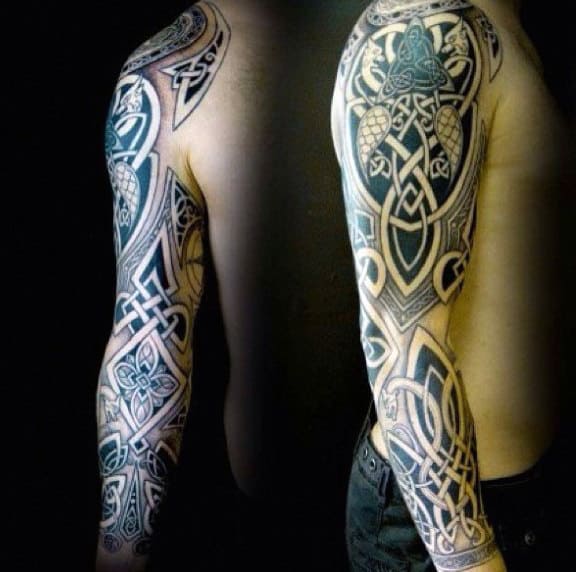 Arm with an elaborate black and grey Celtic tribal tattoo sleeve design