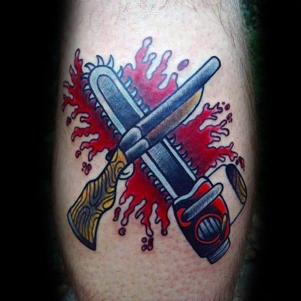 Bold cartoon-style tattoo of a shotgun and chainsaw crossed over a dramatic red blood splatter, blending action and horror themes.