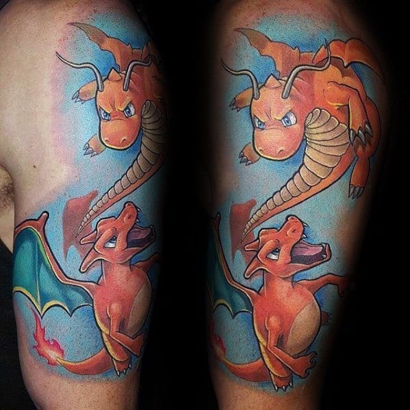 Colorful upper arm tattoo of Charizard and Dragonite in flight with bright blue background and playful, animated expressions.
