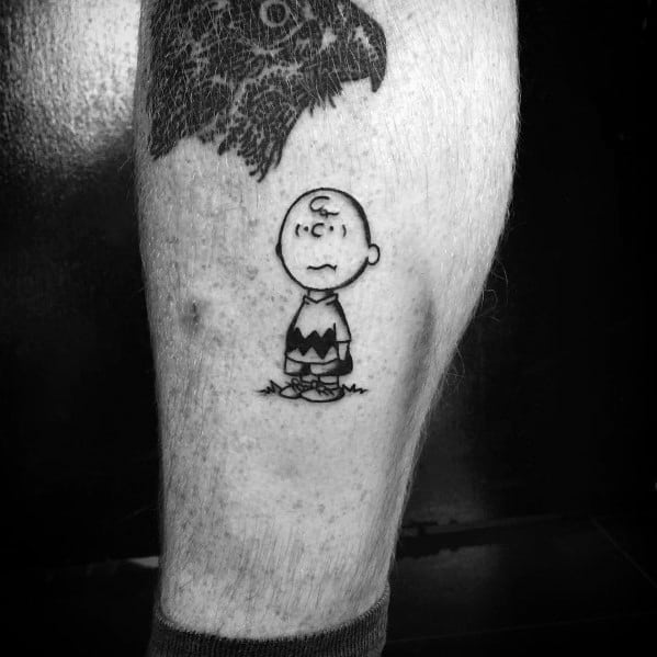 Simple black and white Charlie Brown tattoo with a classic worried expression, capturing his iconic sense of uncertainty and nostalgia.
