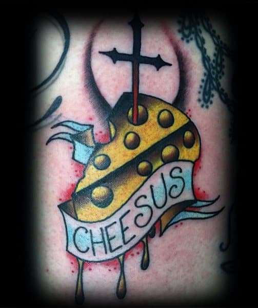 Colorful tattoo of a Swiss cheese wedge pierced by a cross, with a banner reading "CHEESUS" and dripping cheese, featuring bold outlines and shading.