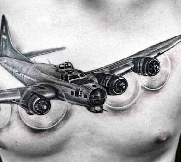Chest tattoo of a detailed four-engine airplane with propellers rendered in black and gray ink