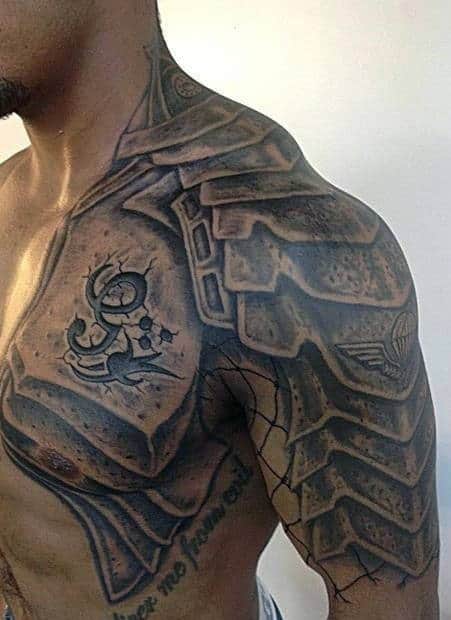 A man with an intricate armor tattoo covering his shoulder and upper chest