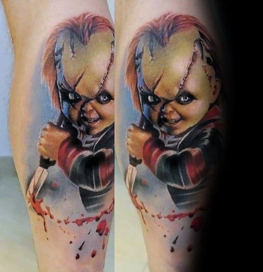 Realistic Chucky tattoo with intense shading, featuring his sinister grin, stitched face, and a bloodied knife for a chilling horror-inspired design.