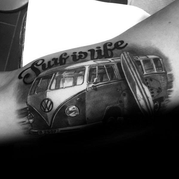 Black and gray tattoo of a Volkswagen van with a surfboard and the phrase "Surf is life" above, symbolizing a laid-back beach lifestyle.