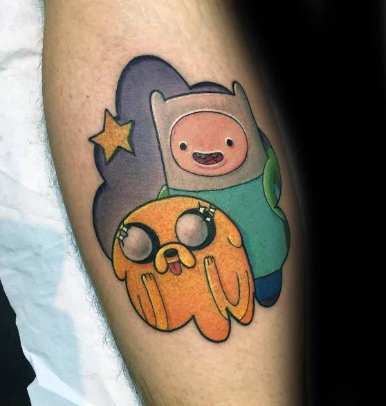 Adventure Time tattoo of Finn and a wide-eyed Jake with a purple background and yellow star, inked on the forearm.