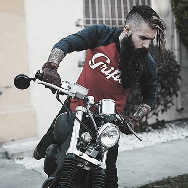 Man with Long Black Beard and Undercut Hair on a Bike