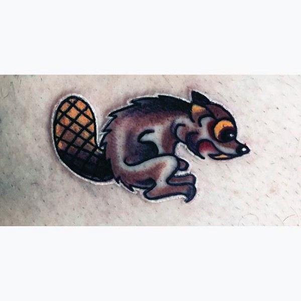 Small cartoon beaver tattoo with exaggerated features, orange eyes, and a textured tail, outlined in white for a sticker-like effect.