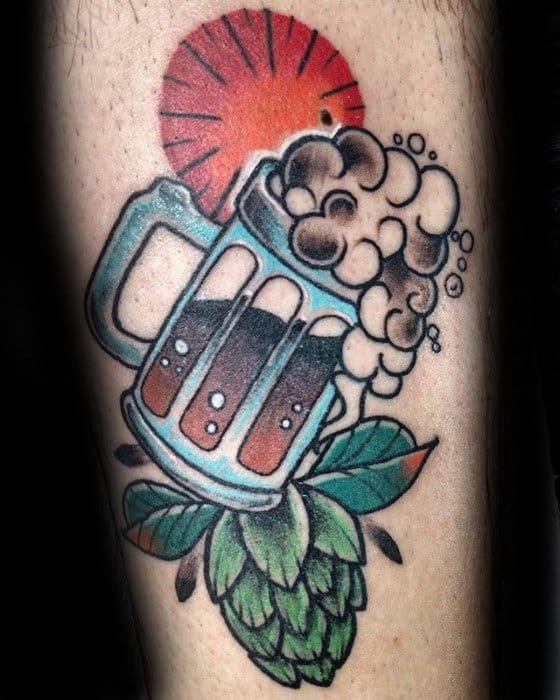 Bold neo-traditional tattoo of a frothy beer mug resting on a hop cone, with a radiant red sun in the background and rich, saturated colors throughout.
