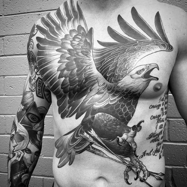 Black and grey chest tattoo featuring a highly detailed eagle with outstretched wings, sharp talons, and realistic shading for a bold and dynamic design.