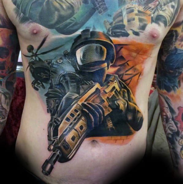 Epic Call of Duty battlefield tattoo covering the stomach, featuring a futuristic soldier, helicopters, explosions, and intense war zone details.