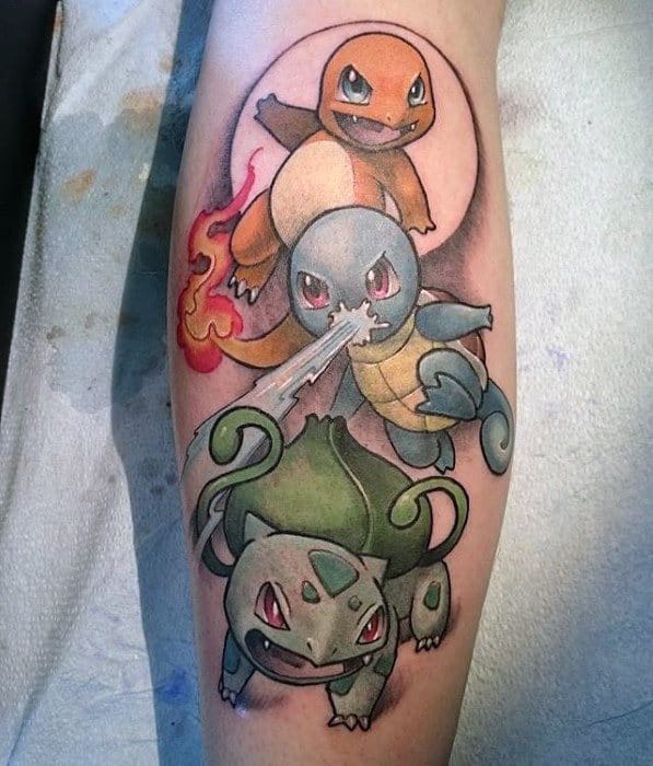 Dynamic tattoo of Charmander, Squirtle, and Bulbasaur stacked in battle-ready poses with fire, water, and vine attacks on a shaded calf background.