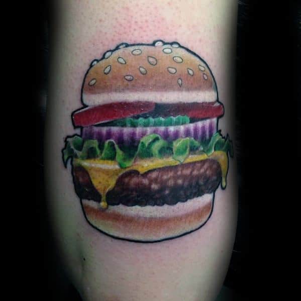 Cheeseburger tattoo complete with lettuce, onion, and tomato inked on skin
