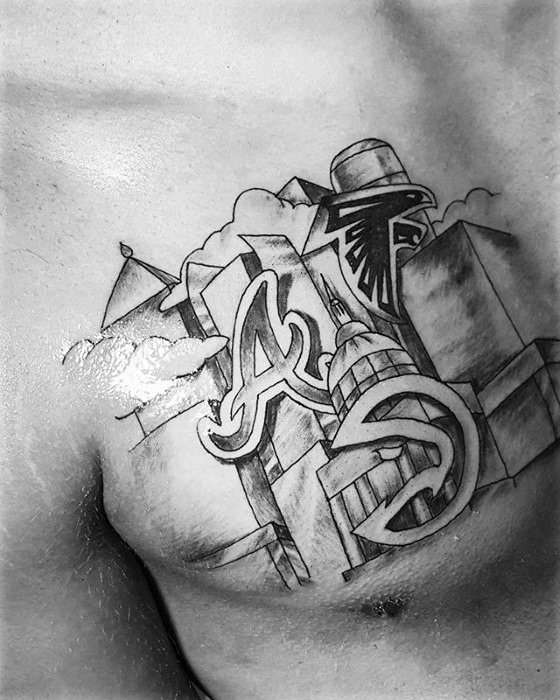 Black and gray chest tattoo featuring Atlanta skyline, Falcons logo, Braves “A”, Hawks symbol, and Georgia State Capitol.