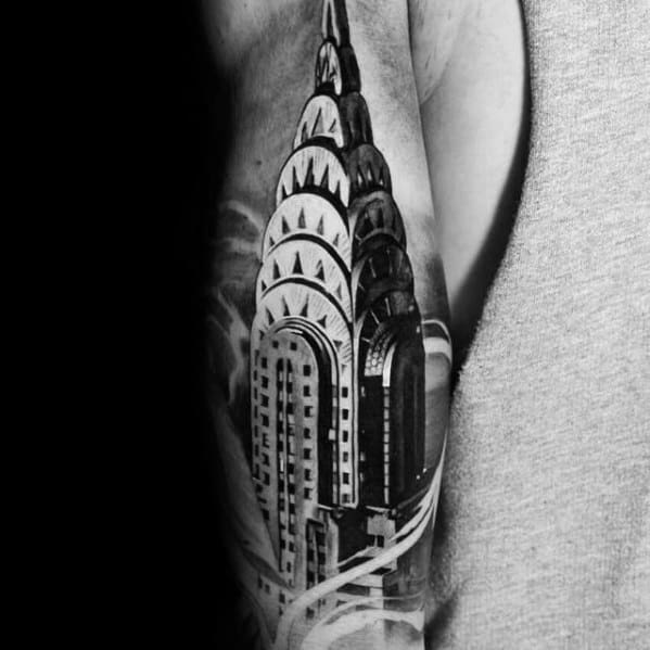 Realistic black-and-grey Chrysler Building tattoo with bold contrast and fine details, creating a striking architectural sleeve design.