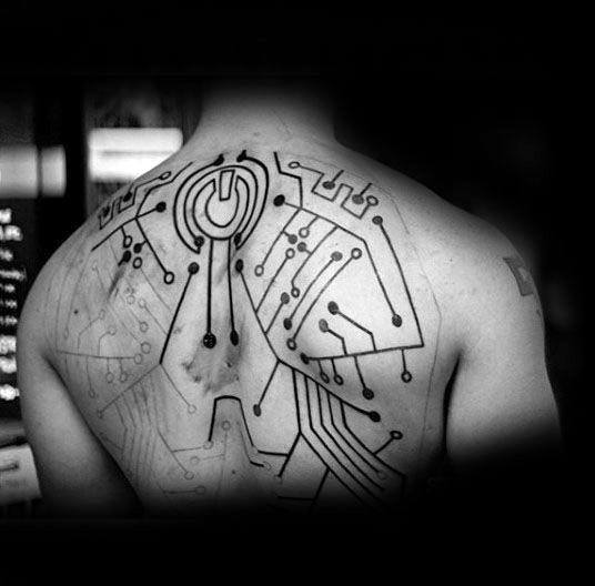 Large circuit board tattoo spanning the upper back, centered around a bold power symbol at the base of the neck.