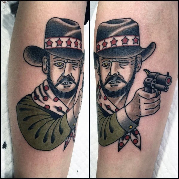 Tattoo of a cowboy with a beard, wearing a hat and polka-dotted bandana, aiming a revolver, done in bold traditional style with strong outlines.