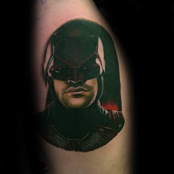 Realistic Daredevil tattoo in his tactical suit with dark shading and a serious gaze, highlighting the gritty tone of the character.