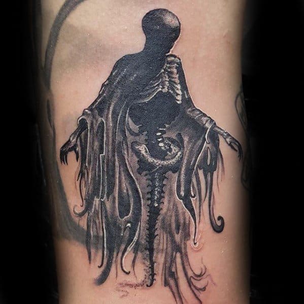 Realistic black and grey Dementor tattoo with exposed spine and ribcage, tattered cloak, and a haunting, shadowy presence.