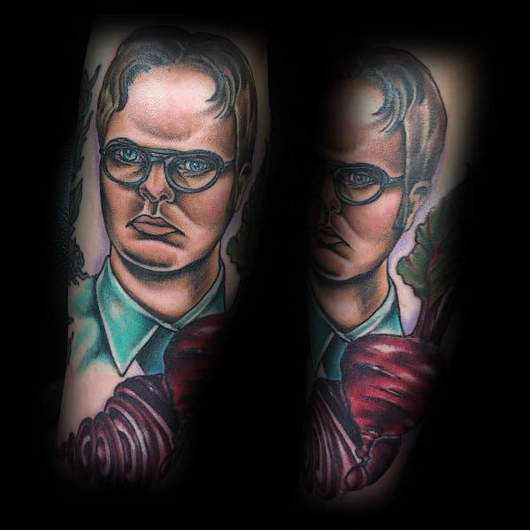 Tattoo of Dwight Schrute with a serious expression, wearing glasses and a green shirt, holding a large beet with detailed shading and bold colors.