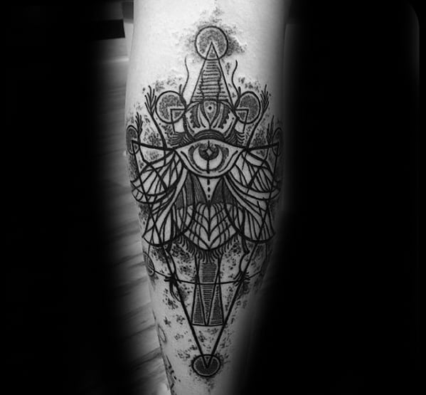 Tattoo of an intricate symmetrical design with all-seeing eyes, geometric shapes, sacred symbols, and ornate abstract detailing.