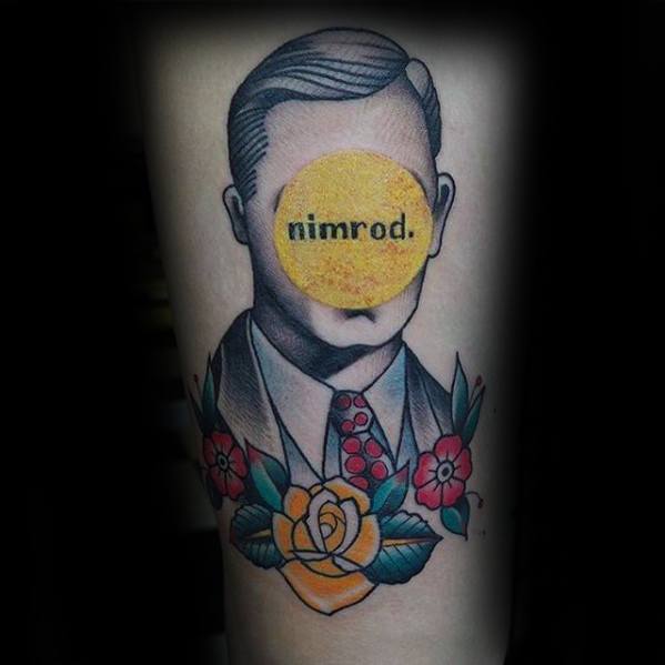 Tattoo of a faceless suited man with a yellow "nimrod." circle over his face, accented by colorful flowers beneath the portrait.