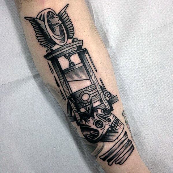 Blackwork guillotine tattoo with bold outlines, a winged helmet at the top, and a decapitated head with dramatic shading at the base.