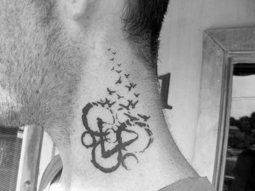 Neck tattoo of the Coheed and Cambria Keywork symbol with a flock of birds flying upward, blending music symbolism with a sense of freedom.
