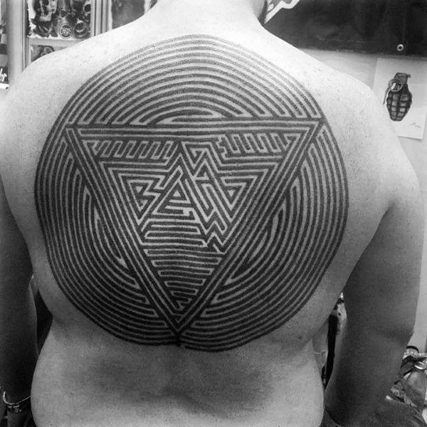 Large geometric labyrinth tattoo covering a man's back, featuring a circular maze with an intricate triangular pattern at the center.
