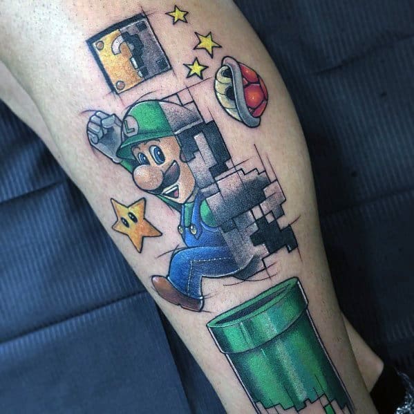 Colorful tattoo of Luigi jumping with pixelated effects, surrounded by Super Mario elements like a warp pipe, Super Star, red shell, and question block.