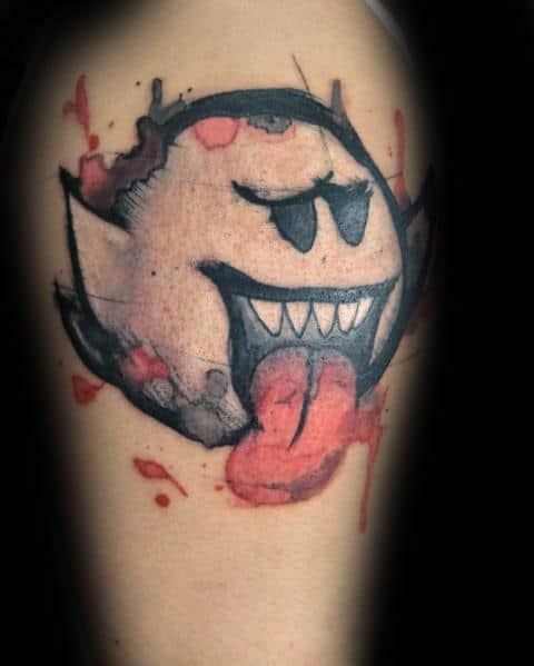 Mario ghost tattoo featuring a dark, sinister Boo with a fierce grin, bold black shading, red splatter effects, and an intense, horror-inspired design.