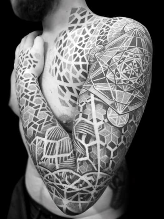 Full arm and chest tattoo with Metatron’s Cube, complex geometric patterns, dotwork shading, and high-contrast blackwork forming a unified design.