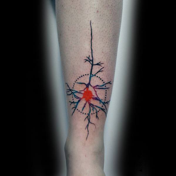 Colorful neuron tattoo on leg with bold black branches, a bright red-orange cell body, and dotted circular design elements.