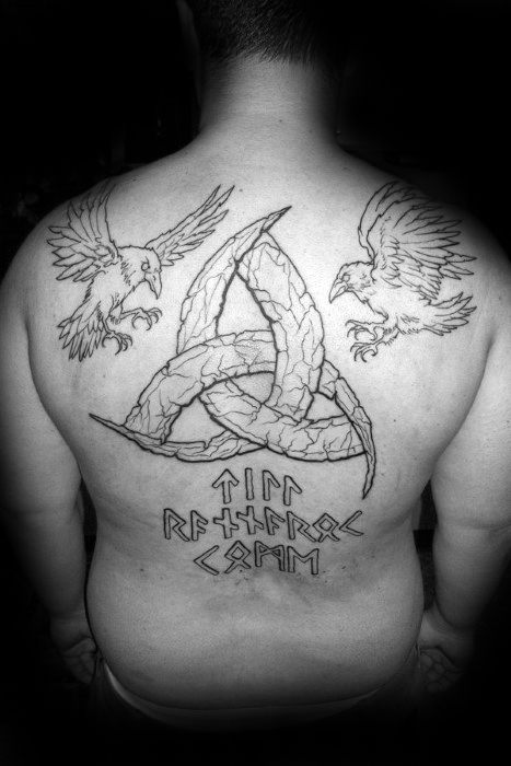 Large back tattoo featuring Huginn and Muninn above a stylized Valknut with Norse runes below, symbolizing Odin and Ragnarok.