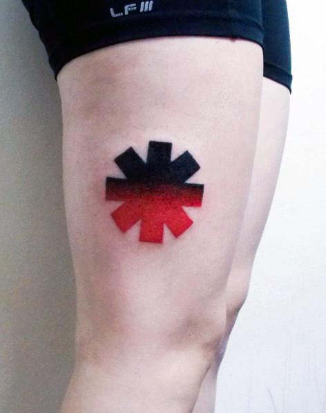 Thigh tattoo featuring the Red Hot Chili Peppers logo with a bold black-to-red gradient, creating a simple yet striking design.