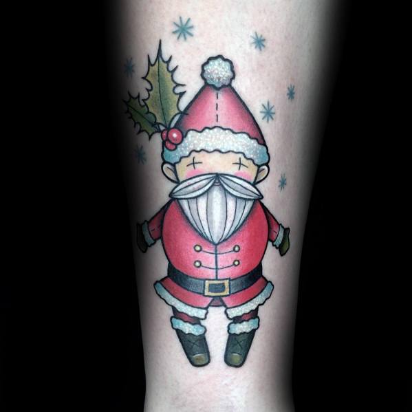 Cute and cartoon-style Santa Claus tattoo featuring a simple, chibi-inspired design with holly accents and snowflakes for a festive touch.