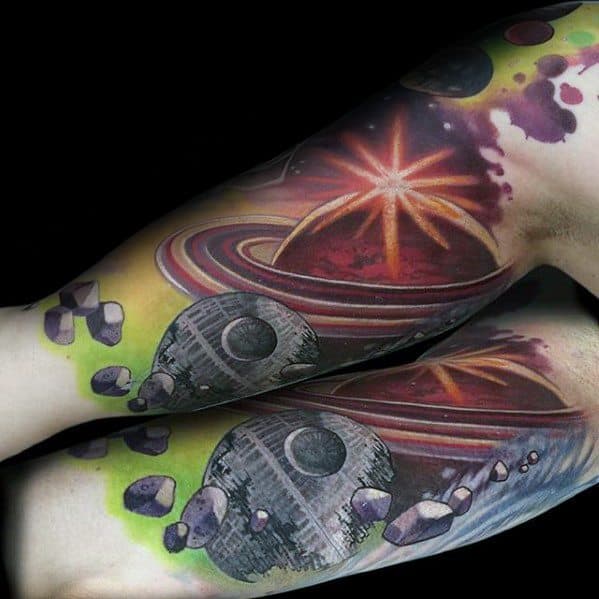 Colorful Saturn tattoo design for men with a galactic theme, glowing starburst, asteroids, and a sci-fi space station in vibrant hues.