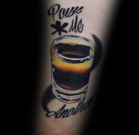 Realistic shot glass tattoo with layered dark and golden liquid, featuring the phrase "Pour Me Another" in bold script for a dynamic look.