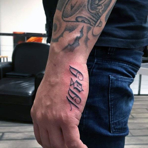 Side hand tattoo for men displaying the year 1997 in a vertical gothic-style font along the outer edge of the hand.