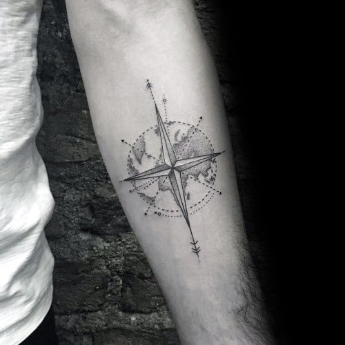 Minimalist compass tattoo with fine dotwork and a world map overlay, symbolizing travel, exploration, and a sense of direction.