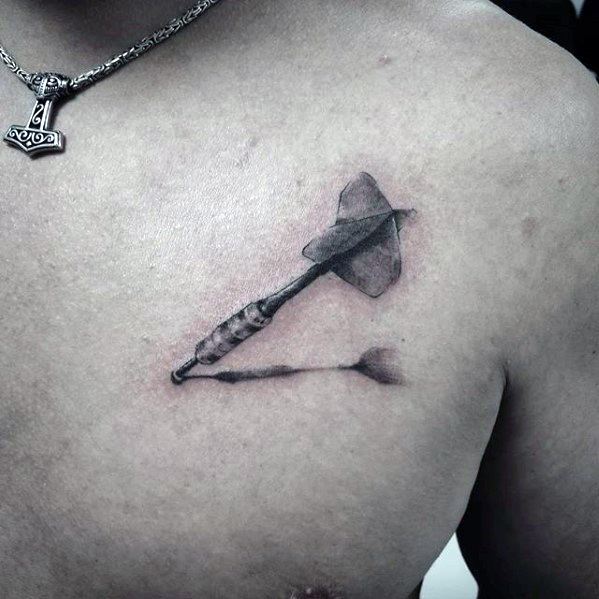 Chest tattoo of a dart with a realistic shadow beneath it, giving a floating effect that symbolizes precision and strength.