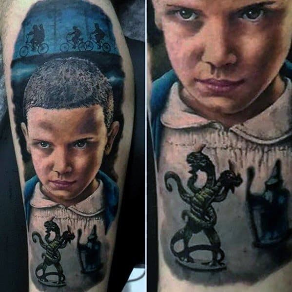 Highly detailed tattoo of Eleven with a determined look, silhouettes of kids biking above, and the Demogorgon below on her dress.