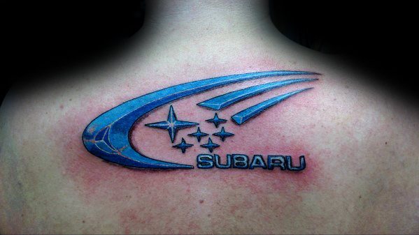 Bold blue Subaru logo tattoo on the upper back, featuring the iconic six-star emblem with dynamic swoosh lines and a 3D effect.