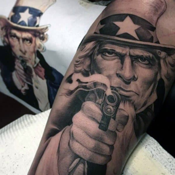 Hyper-realistic Uncle Sam tattoo aiming a smoking gun, capturing a fierce expression with intense detail and smooth black and gray shading.