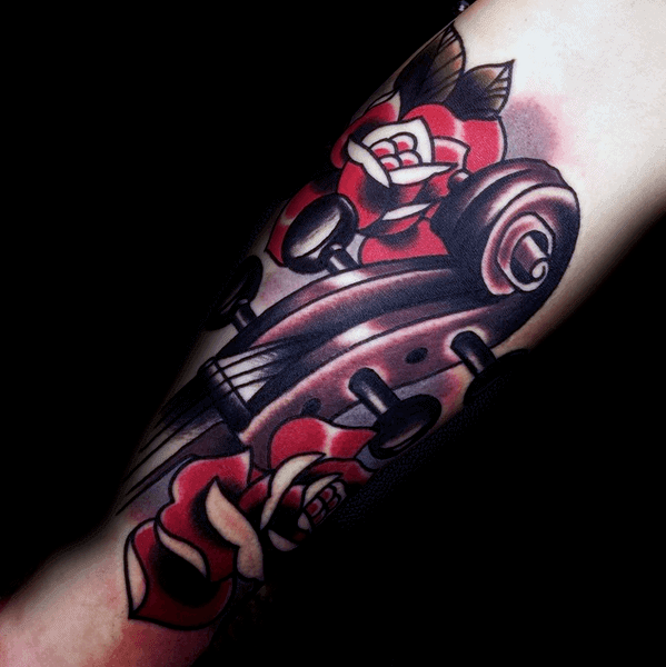 Bold neo-traditional tattoo of a violin scroll surrounded by red roses, featuring thick outlines and deep shading on the forearm.