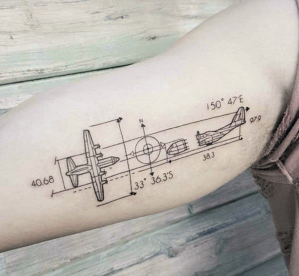 Technical airplane coordinate tattoo on the bicep with blueprint-style linework, featuring precise measurements and geographic coordinates.