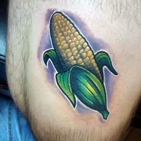 Bold tattoo of a corn cob with vibrant green husks and golden kernels, featuring strong shading and a glowing effect for a dynamic look.