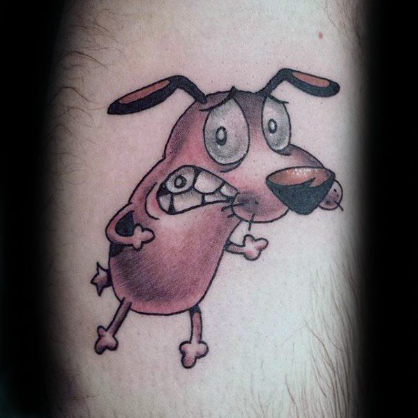 Tattoo of Courage the Cowardly Dog with a shy, nervous expression, slightly hunched posture, and subtle shading on the arm.